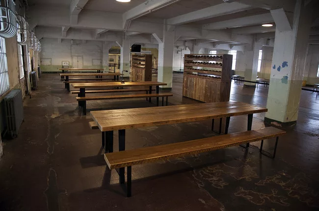In the prison dining room, <em>Yours Truly</em> invites Alcatraz’s visitors to write messages on postcards pre-addressed to prisoners of conscience around the world.
