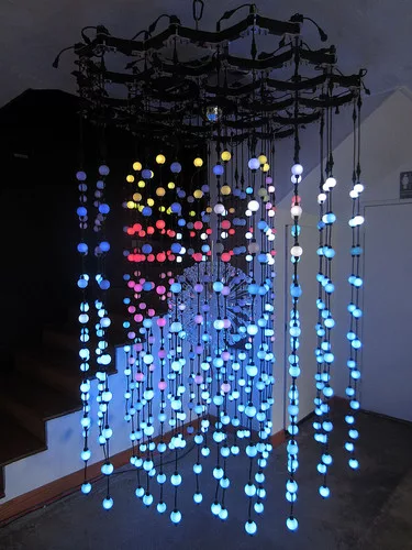 The light chandelier in <em>Domus</em> measures is suspended from the apex of the yurt. The LED lights emit light pulses in response to real-time seismic data.
