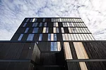 The building is clad in cedar that has been charred to reduce flame spread.