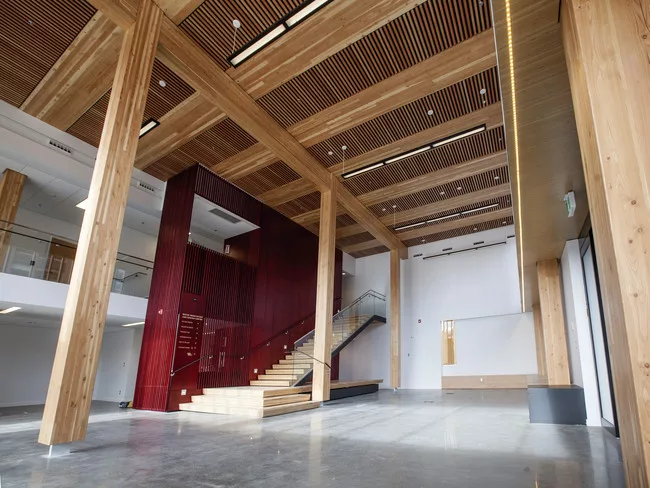 The timber post-and-beam structure is visible throughout the WIDC, including the double-story foyer.
