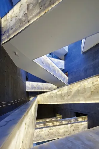 The museum provides a muscular architectural experience as seen in these alabaster-clad passageways that crisscross through the structure.