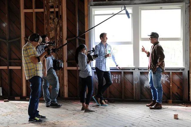 The film crew, including Bassett (center) talks to John Boiler, CEO of 72andSunny, a design and advertising agency.<div id='_mcePaste'>