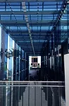 Sou Fujimoto’s two-story porch, made of sheets of thick blue glass, provides a facade for the half a dozen stores under construction behind it.<div id='_mcePaste'>﻿﻿