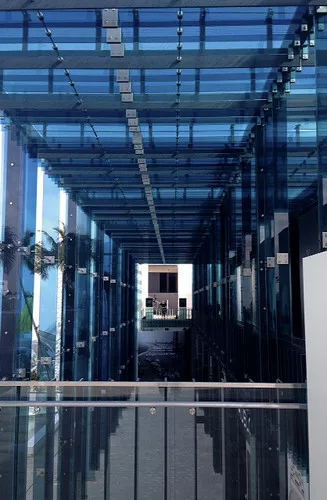 Sou Fujimoto’s two-story porch, made of sheets of thick blue glass, provides a facade for the half a dozen stores under construction behind it.<div id='_mcePaste'>
