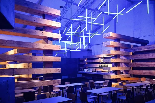 Olson Kundig Architects stacked and staggered glu-lam beams into a handsome, comfortable lounge for Design Miami. The chandelier is by Lilienthal | Zamora.<br /><div id='_mcePaste'>