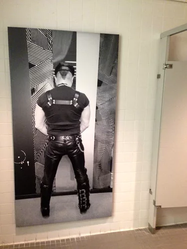 In a men's bathroom at the Bass Museum, a photo of Peter Marino suggests the room's use.<div id='_mcePaste'>