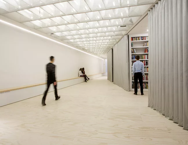 The Van Alen's new storefront space in Manhattan's Flatiron district joins a large event space to a series of alcoves that can be hidden behind accordion doors during public programs.<div id='_mcePast