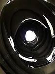 Inside 'Black Hole,' which opens to the sky. The oculus features wood discs of varying openings.