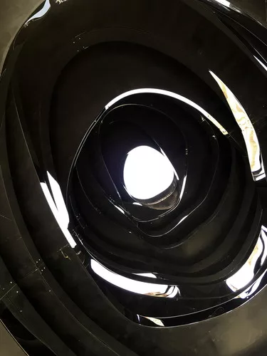 Inside 'Black Hole,' which opens to the sky. The oculus features wood discs of varying openings.