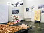 The six finalist designs are suspended over a model of Helsinki.