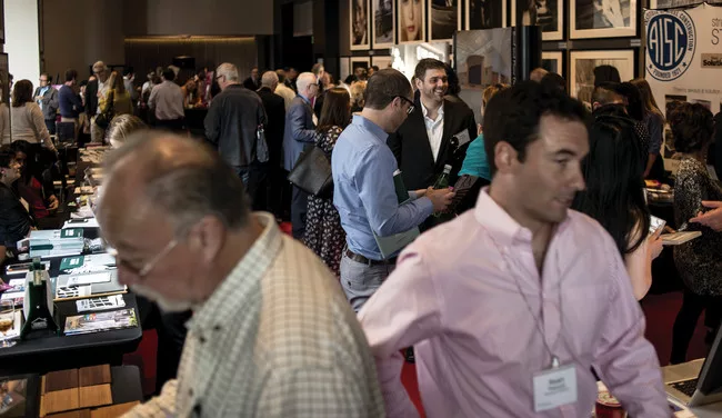 Attendees visit the exhibitors hall between sessions.
