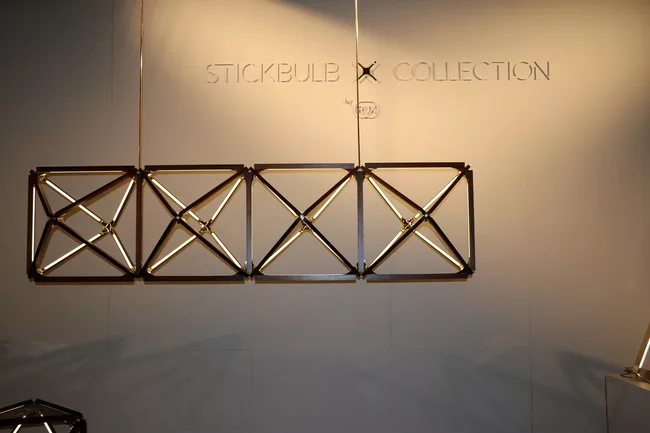 Modular chandeliers comprised of brass, wood, and LEDs are part of Long Island City-based RUX’s new Stickbulb X Collection.<div id='_mcePaste'>