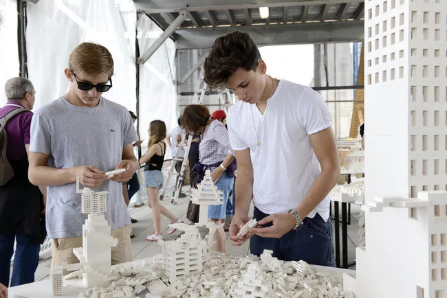 Visitors add their own LEGO creations to the Eliasson work.