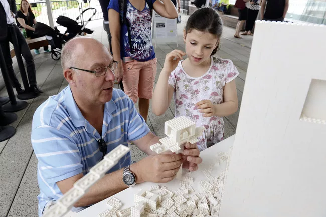 Visitors add their own LEGO creations to the Eliasson work.