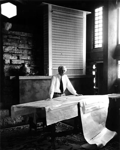 Frank Lloyd Wright stands at the drafting table in his studio at Taliesin, Wisconsin, 1947, photographed by Pedro E. Guerrero.