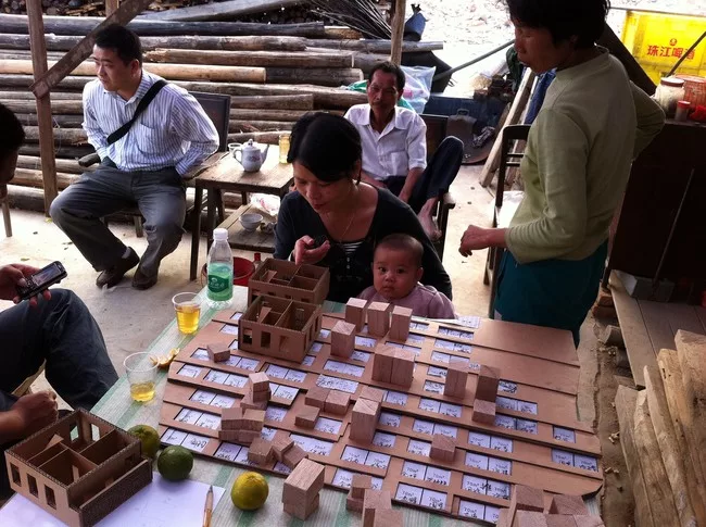 Villagers with a model of the Shijia prototype.