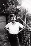 A young Kengo Kuma in front of his home.