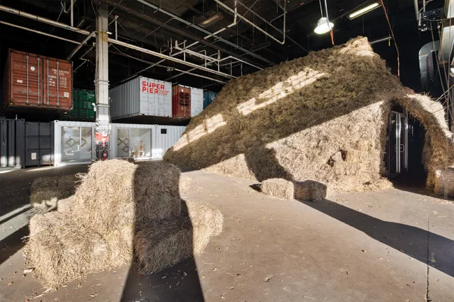 For a pop-up store for menswear-designer Michael Bastian in 2013, the architects concealed two shipping containers in a haystack inside a pier shed along Manhattan's West Side Highway.