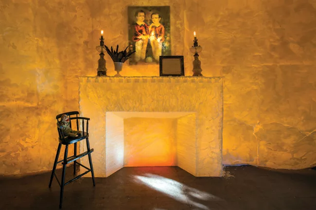 The <em>American Gothic</em>-esque space has beeswax-covered walls, a fireplace, and curtains of black feathers. 'They approach spaces in a different way from most people. It's more a mood for them,' 