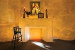 The <em>American Gothic</em>-esque space has beeswax-covered walls, a fireplace, and curtains of black feathers. 'They approach spaces in a different way from most people. It's more a mood for them,' 