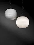 Designed by Ludovica + Roberto Palomba for Foscarini, this pendant gets its ethereal appearance from a white blown-glass sphere with a subtle bas relief of facets formed by crisscrossing grooves. The 