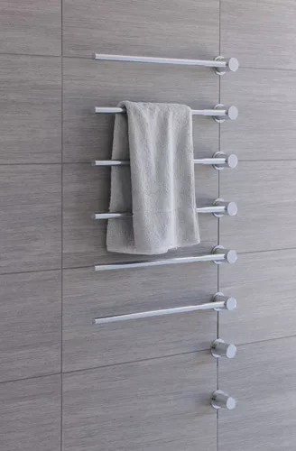 Like all other Vola fixtures, the T39EL Towel Warmer is minimalist and sculptural in design. It consists of three to 20 bars that can be spaced 4” to 12” apart on the wall, has an auto-shu