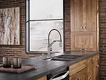This single-handle, articulating-arm kitchen faucet by Brizo is reminiscent of the classic Luxo task light with a flexible pull-down design. When the two-function spray wand is undocked, the user can 