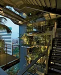 A vertical garden planted with palm trees cuts through the center of the tower. Guests access rooms via galleries overlookingthe greenery.