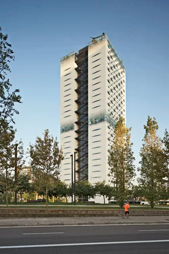 The southern exposure features narrow oval view openings to mitigate solar load.