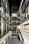 Three atriums topped with tall clerestory glazing bring daylight into the center of each office block. By varying the design of the multistory spaces, the architects gave each atrium its own identity.