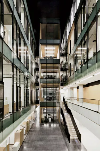 Three atriums topped with tall clerestory glazing bring daylight into the center of each office block. By varying the design of the multistory spaces, the architects gave each atrium its own identity.
