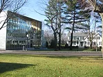 The headmaster's house reflects off of the science center's front facade.