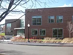 The back of the building has an entrance into the central gathering space, and is lined with rainwater gardens.