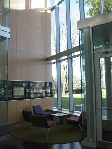 A small lounge inside the building's main entrance features a 'green mural,' which includes an interactive touch screen with minute-by-minute information on building resource consumption and solar ene