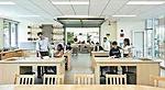 Garage doors connect classroom-labs, which feature “Harkness” seminar tables next to lab benches, underscoring the school’s commitment to active learning.