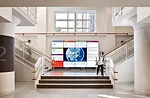 An interactive media wall dominates the grand stair that leads to the cafeteria and the High Line.