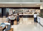 Encased in deep- green-glazed tile, the food-service station is open on two sides to dish up the day's specials on marble counters to both upper- and lower-school children. Small teaching kitchens al