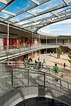 A large, round central courtyard, surrounded by covered walkways, is a hub of activity.