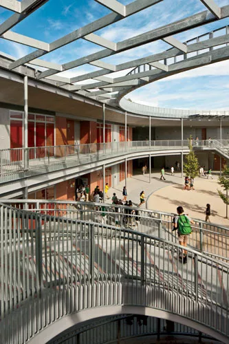 A large, round central courtyard, surrounded by covered walkways, is a hub of activity.