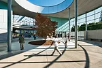A smaller round courtyard serves as both main entry and outdoor reading room.