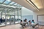 A skylit flexible classroom overlooks the indoor-outdoor lunch shelter.