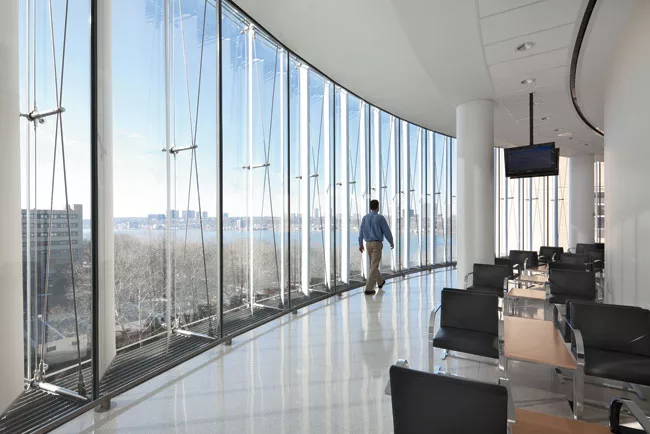 The cable-truss-supported, double-walled facade gives waiting rooms a clear view of the Hudson.