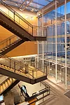 A steel stair in the lobby leads to second- and third-floor bridges that direct visitors to the north or south pavilion.