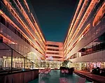 The podium- credits level courtyard accommodates outdoor dining, which is enlivened by the changing colors of LED s behind the aluminum screens.