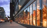 Vertical baffles carrying photographic images of Frazier back the glass curtain wall along Tenth Avenue.