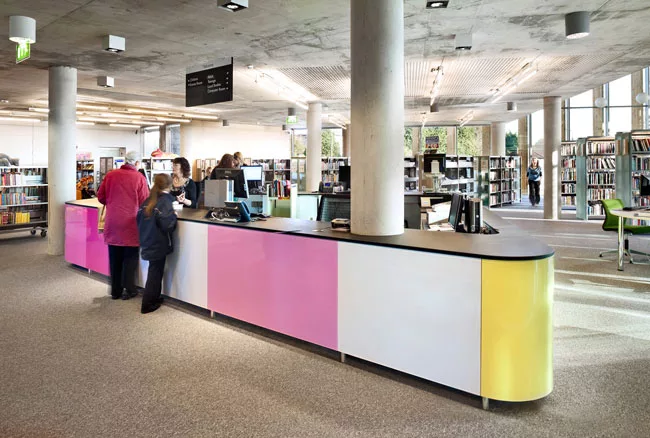 Enamel panels set flush in the library's reception counter provide colorful accents to the interior.