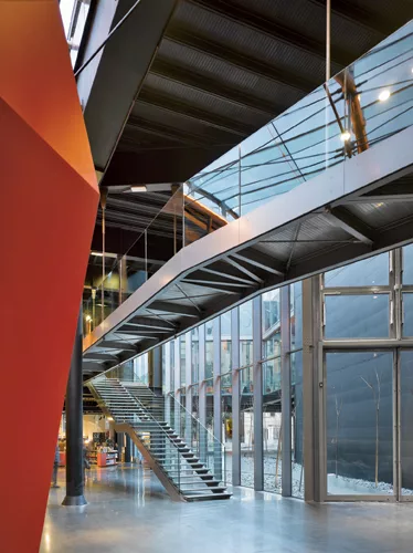 A suspended walkway zigzags through the main atrium, taking visitors on a journey that ends on the building's roof.