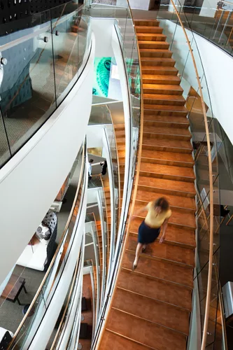 By using larger glass smoke skirts and extra sprinklers, NBBJ was able to keep staircases open for six flights.