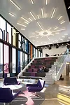 A stair in the lounge at the building's northeast corner is wide enough to perform double-duty as vertical circulation and seating.