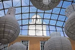 Diaphanous, gourd-shaped sculptures by artist Kendall Buster are suspended from the atrium's tension-grid glazed roof.